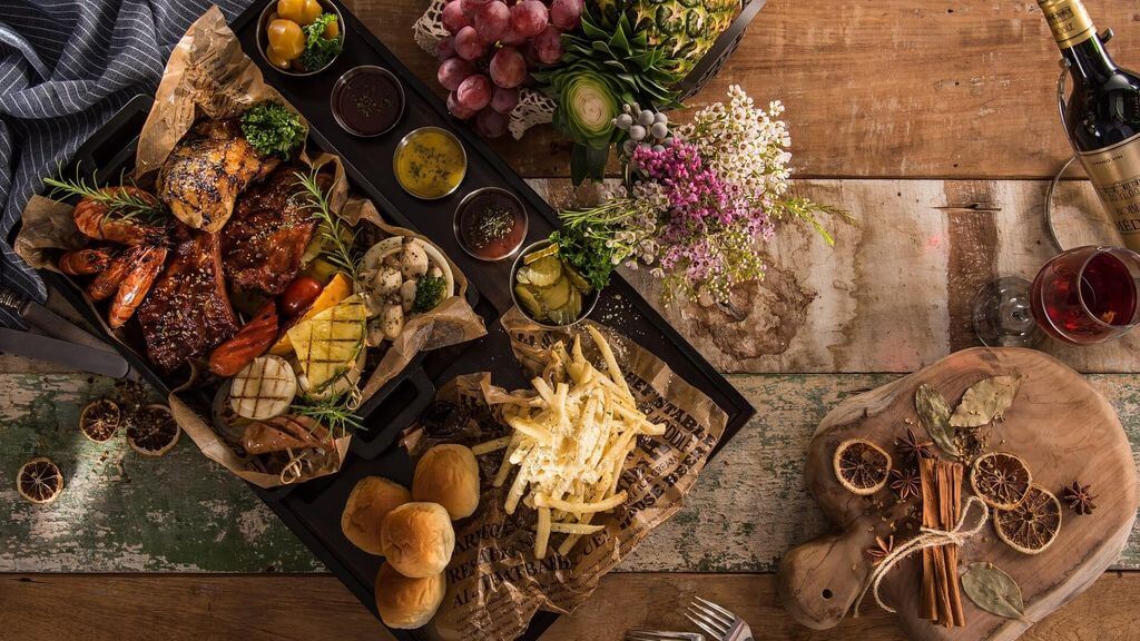 Food plate with bread, cheese, fruits and wine