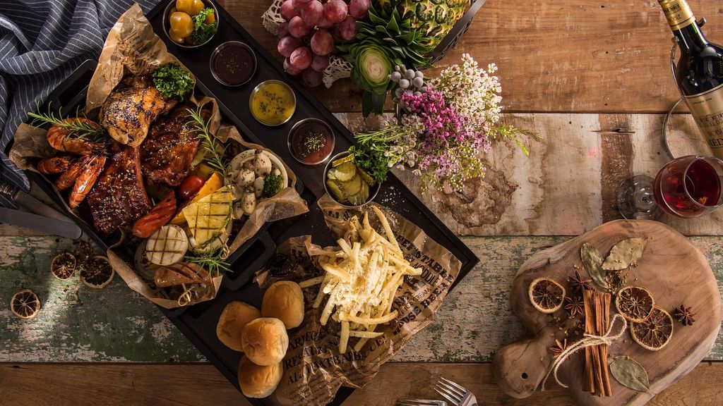 Food plate with bread, cheese, fruits and wine